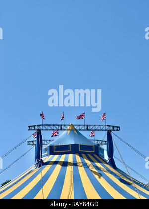 17 avril 2025 - Cambridge, Royaume-Uni - Une tente de cirque Big Top avec des drapeaux de l'Union Jack britannique volant un jour d'été. Banque D'Images