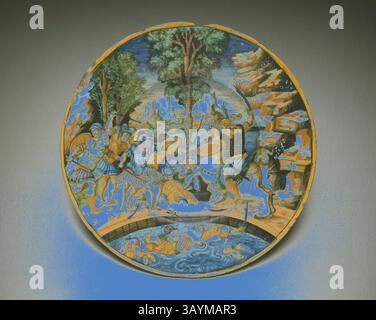 Pièce décorative circulaire représentant une scène vibrante de guerriers engagés dans la bataille au milieu d'un paysage luxuriant, avec des détails complexes mettant en valeur leur armure et leurs expressions. Entourant l'action centrale, des eaux sereines et des arbres encadrent le drame, ajoutant une paix contrastée à la lutte chaotique. Plaque avec Horatio au pont, v. 1535, italien, Urbino, Urbino, faïence émaillée en étain (maiolica), diamètre : 26 cm (10 1/4 po.) Art classique avec une touche moderne réinventé par Artotop Banque D'Images