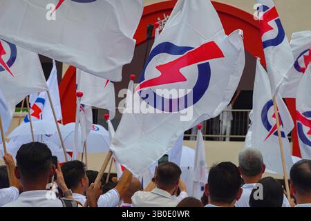 Singapour 2025 avr 23 - les partisans du PAP se sont vêtus de drapeaux du parti en vague blanche devant l'école de Chongfu le jour de la nomination lors des élections générales de Singapour Banque D'Images