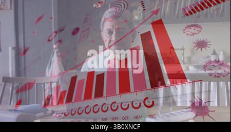 Image de graphiques et de cellules virales sur un homme senior biracial triste assis seul à la maison Banque D'Images