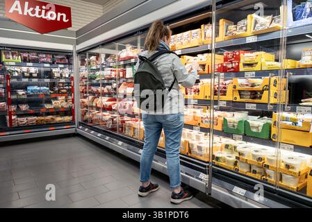 Hambourg, Allemagne. 23 avril 2025. Un client regarde les produits sur une étagère réfrigérée. Crédit : Markus Scholz/dpa/Alamy Live News Banque D'Images