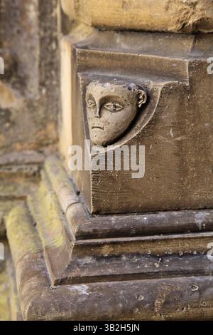 Des sculptures ornées de visages décorent la maçonnerie du monastère de Batalha, mettant en valeur l'artisanat médiéval et l'art artistique Banque D'Images