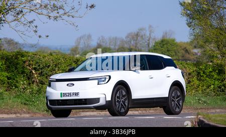 Whittlebury,Northants.,.UK - 27 avril 2025 : 2025 Ford Explorer voiture électrique conduisant sur une route de campagne anglaise. Banque D'Images