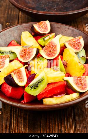 Bol rempli de fruits frais sur une table en bois rustique. Banque D'Images