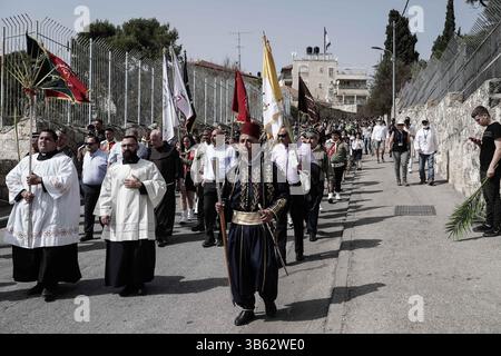 10 avril 2022, Jérusalem, Israël : des milliers de pèlerins chrétiens célèbrent le dimanche des Rameaux descendant du Mont des oliviers vers Jérusalem biblique, alors qu’ils retracent les pas de Jésus. La procession a commencé à l'église de Bethphage du IVe siècle, sur les pentes orientales du Mont des oliviers, traditionnellement le lieu où Jésus a commencé son entrée triomphale à Jérusalem, est monté au sommet puis est descendu vers l'ouest à Gethsémani, la porte Lionsâ€™ et à l'église d'Anne. (Crédit image : © Nir Alon/ZUMA Press Wire) Banque D'Images