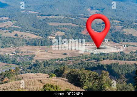 Icône d'épingle de localisation sur un champ d'herbe montrant le concept immobilier. Terrain à vendre. L'épingle de localisation rouge vif se tient bien en évidence sur un champ vert, reprep Banque D'Images