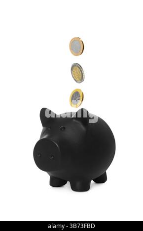 Pièces tombant dans la tirelire noire sur fond blanc Banque D'Images