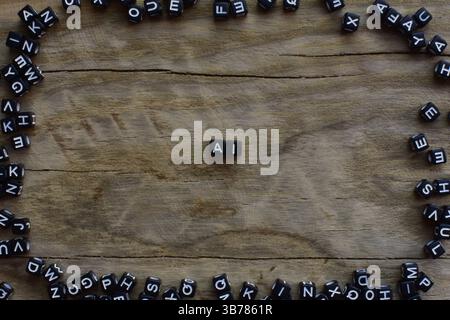 Symboles ai fait de perles en plastique noir sur fond de bois fissuré encadré en diverses lettres. Concept de lettres ai avec espace de copie. Banque D'Images