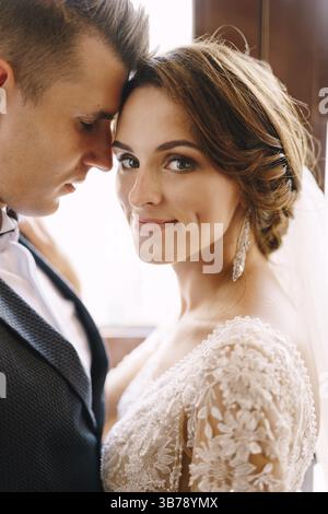 Photo de mariage d'art au Monténégro, Perast. Portrait d'un couple de mariage en gros plan. Le marié repose son front contre le temple des épouses. La mariée Banque D'Images