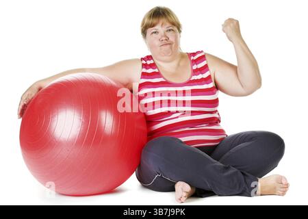 Grosse femme avec une grosse boule cardan rouge Banque D'Images