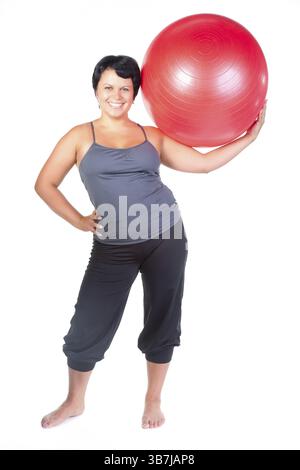 Grosse femme avec une grosse boule rouge Banque D'Images