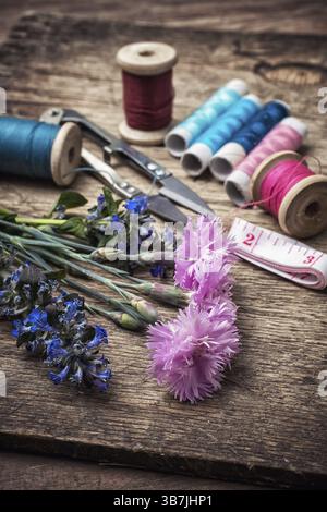 Ciseaux, fil et boutons sur fond de darianna non taillé dans un style vintage Banque D'Images