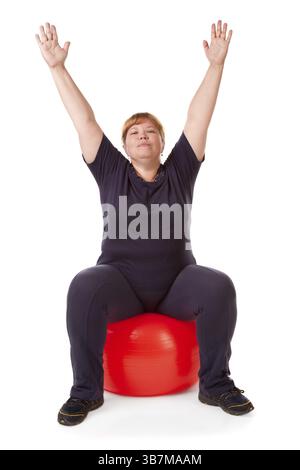 Grosse femme avec une grosse boule cardan rouge Banque D'Images