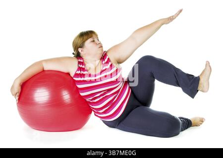 Grosse femme avec une grosse boule cardan rouge Banque D'Images