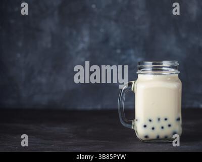 Le lait fait maison bubble tea avec perles de tapioca de boules. Taiwan populaires bubble tea dans verre pot Mason avec copie espace pour le texte. Bubble tea sur the backgrou Banque D'Images