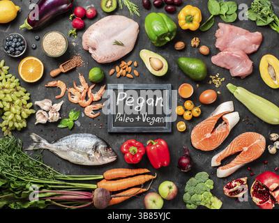 Régime alimentaire Pegan conept. Plus Vegan diet paléo ingrédients alimentaires - légumes, fruits, viande et poisson sur fond sombre. Vue supérieure ou télévision lay Banque D'Images