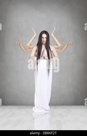 Belle femme avec beaucoup de mains sur fond blanc Banque D'Images
