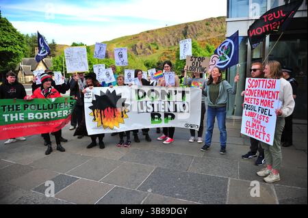 Édimbourg, Royaume-Uni. 13 mars 2025 - des manifestants sont vus tenant des banderoles et des pancartes à l'extérieur du bâtiment du Parlement écossais. Des militants se sont rassemblés devant le Parlement écossais pour s’opposer à une réception de BP, critiquant l’expansion des combustibles fossiles de la société, la baisse des engagements climatiques et l’approvisionnement en pétrole d’Israël. Ils ont exhorté les MSP à rejeter le lobbying des entreprises et à soutenir une transition juste vers les énergies renouvelables. Banque D'Images