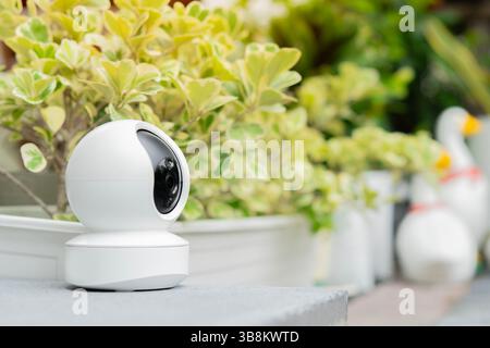 Close up Smart CCTV caméra installée dans le jardin vert à la maison, concept CCTV caméra fonctionnant en regardant la sécurité de la maison. Copier l'espace. Banque D'Images