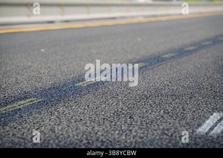 Gros plan de l'asphalte fraîchement posé sur New Highway Road avec des marques claires Banque D'Images