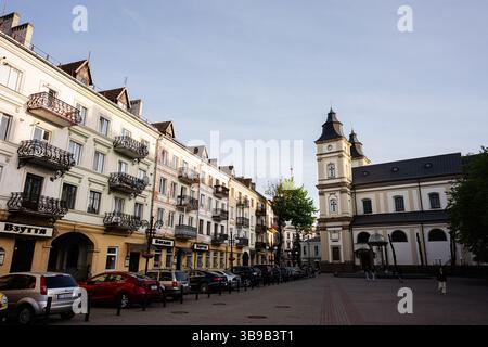 Ivano-Frankivsk, Ukraine - 29 avril 2025 : architecture européenne Ivano-Frankivsk avec une grande église et des balcons complexes sur une place ensoleillée Banque D'Images