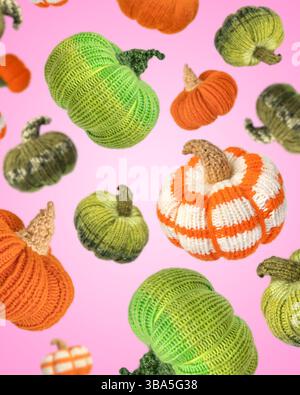 Fond abstrait de citrouilles tricotées volant dans l'air sur fond rose. Jouets à tricoter et décorations décoratives à la maison pour les vacances. Concept d'Halloween, récolte d'automne et Thanksgiving. Banque D'Images