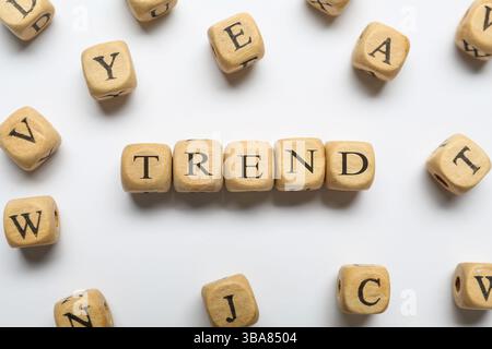 Word Trend fait de cubes en bois avec des lettres sur fond blanc, vue de dessus Banque D'Images