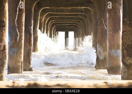 Les vagues se brisent sous la jetée de Manhattan Beach Banque D'Images