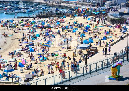 Lyme Regis, Dorset, Royaume-Uni. 18 mai 2025. Météo britannique. Les bains de soleil affluent vers la station balnéaire de Lyme Regis pour se prélasser sous le soleil brûlant. Crédit : Celia McMahon/Alamy Live News Banque D'Images