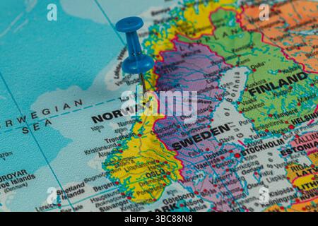 Une carte détaillée montre la Norvège et la Suède, avec des reliefs vibrants clairement soulignés. Une punaise bleue marque un endroit spécifique en Norvège, indiquant int Banque D'Images