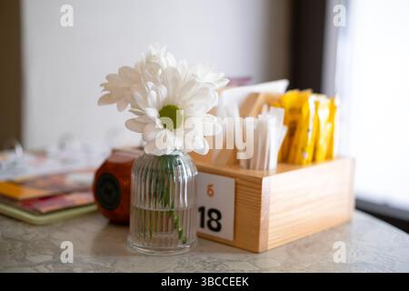 Belles marguerites blanches sur une table dans un restaurant. Banque D'Images