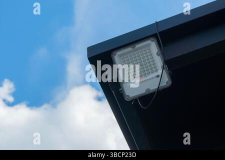Petits panneaux solaires mis en plein air au-dessus du ciel bleu par une journée ensoleillée. Mini panneau solaire pour projecteur LED à la maison. Copier l'espace. Mise au point sélective. Banque D'Images