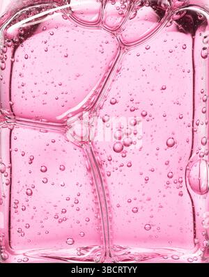 Gel cosmétique rose clair sérum huile bulle texture fond Hyaluronic soin de la peau hydratant échantillon de produit avec bulles macro Banque D'Images