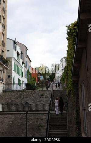 Une charmante rue européenne dispose d'un escalier raide menant à un étroit chemin pavé, encadré par des bâtiments colorés avec volets décoratifs A. Banque D'Images