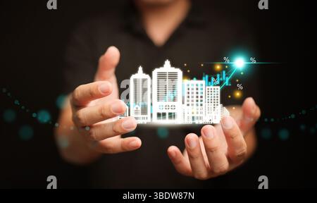 Concept de croissance immobilière avec des icônes de bâtiment et une courbe montante sur la main, symbolisant l'investissement immobilier, l'expansion du marché et le développement immobilier Banque D'Images