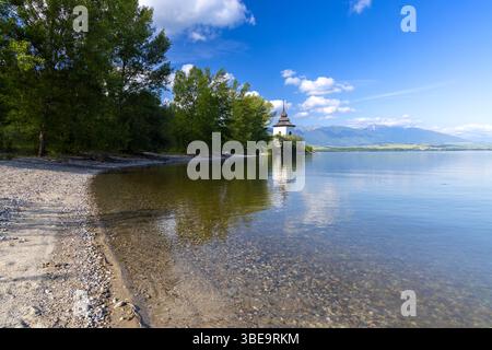 Lac Liptovska Mara avec la tour de l'église inondée reflétant sur la surface de l'eau sous un ciel bleu ensoleillé, Liptovsky Mikulas District, Slovaquie Banque D'Images