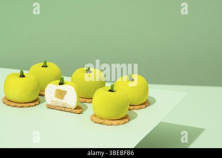 Un plateau de beignets verts assortis est posé sur une table en bois Banque D'Images