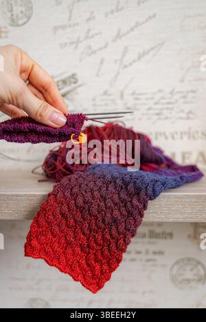 Aiguilles à tricoter dans la main d une femme. Articles tricotés. Chaussettes chaudes faites maison. Motif de couture. Fil de laine de qualité. Vêtements d'hiver. Cadeau de Noël. Banque D'Images