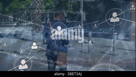 Image du réseau d'icônes de profil sur les nuages contre l'homme d'affaires afro-américain marchant Banque D'Images