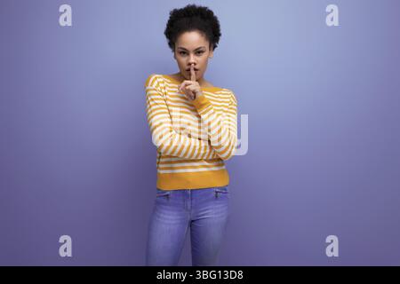 Modèle Latina jeune femme avec cheveux afro sur fond de studio Banque D'Images