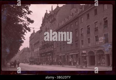 Cette photographie de 1913 montre le Park Hotel à Munich, avec des piétons marchant le long de la Maximiliansplatz. Edmund F. Arras a séjourné à l'hôtel pendant sa tournée européenne. L'hôtel est situé en face de la fontaine de Wittelsbach, un point de repère remarquable de la ville. Banque D'Images