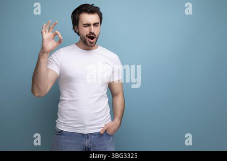 Élégant homme brune brutal dans un T-shirt blanc a eu un aperçu Banque D'Images