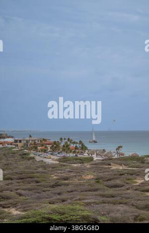Vue côtière d'Arashi bach Aruba avec une gratte-ciel hôtelso en arrière-plan Banque D'Images