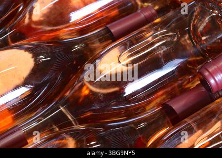 Des bouteilles de vin mousseux Rosé stockées dans une grande cage métallique attendent leur tour dans une étiqueteuse automatisée de Chiltern Valley Wines. Banque D'Images