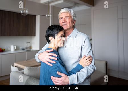Couple anxieux senior embrassant l'un l'autre réconfortant. Soutien de l'amour, problèmes de santé, lien émotionnel Banque D'Images