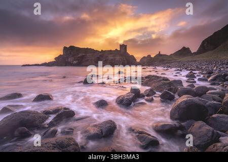Lever de soleil sur les ruines du château de Kinbane sur la Causeway Coast en Irlande du Nord. Banque D'Images