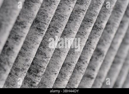 Surface ondulée du filtre à air, gros plan, fond texturé gris abstrait Banque D'Images