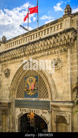 Istanbul, Turquie - 9 novembre 2023 : porte historique nuruosmaniye du Grand Bazar avec briques ornées et porte voûtée contre un ciel bleu vif Banque D'Images
