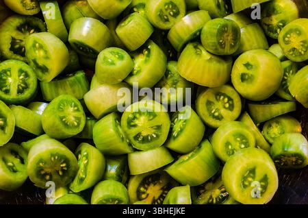 Gros plan d'un groupe de tomates raisin vertes crues tranchées Banque D'Images