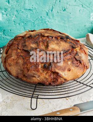 Pain aux raisins secs à l'épeautre avec du beurre sur le côté - un petit déjeuner rustique ou une collation l'après-midi, servi sur une assiette blanche, une planche à découper ou une grille de refroidissement. Banque D'Images